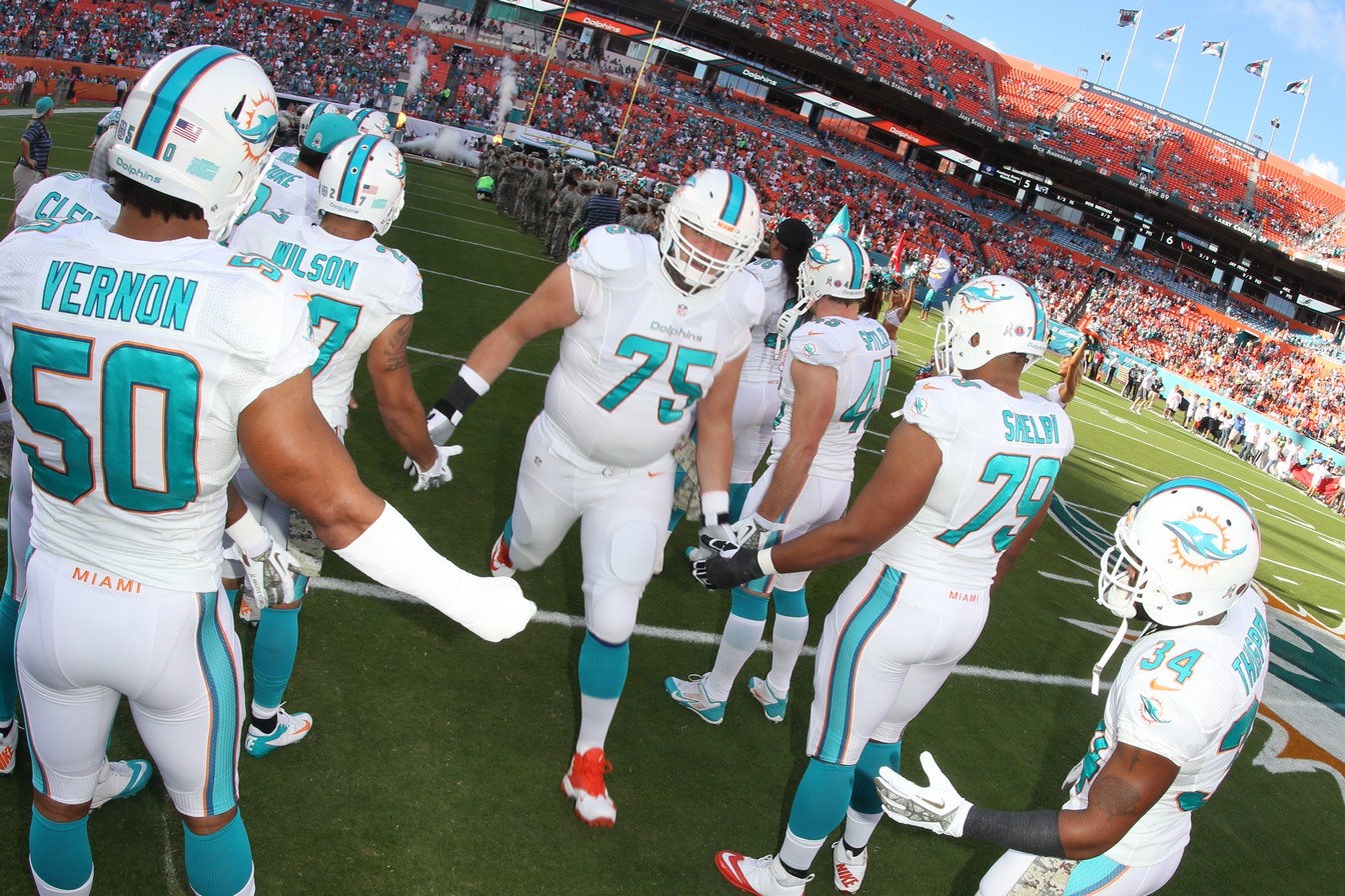 Nate Garner number 75 in the Dolphins offensive line huddle